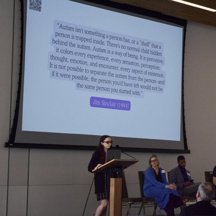 Juliette Gudknecht presenting at a podium.